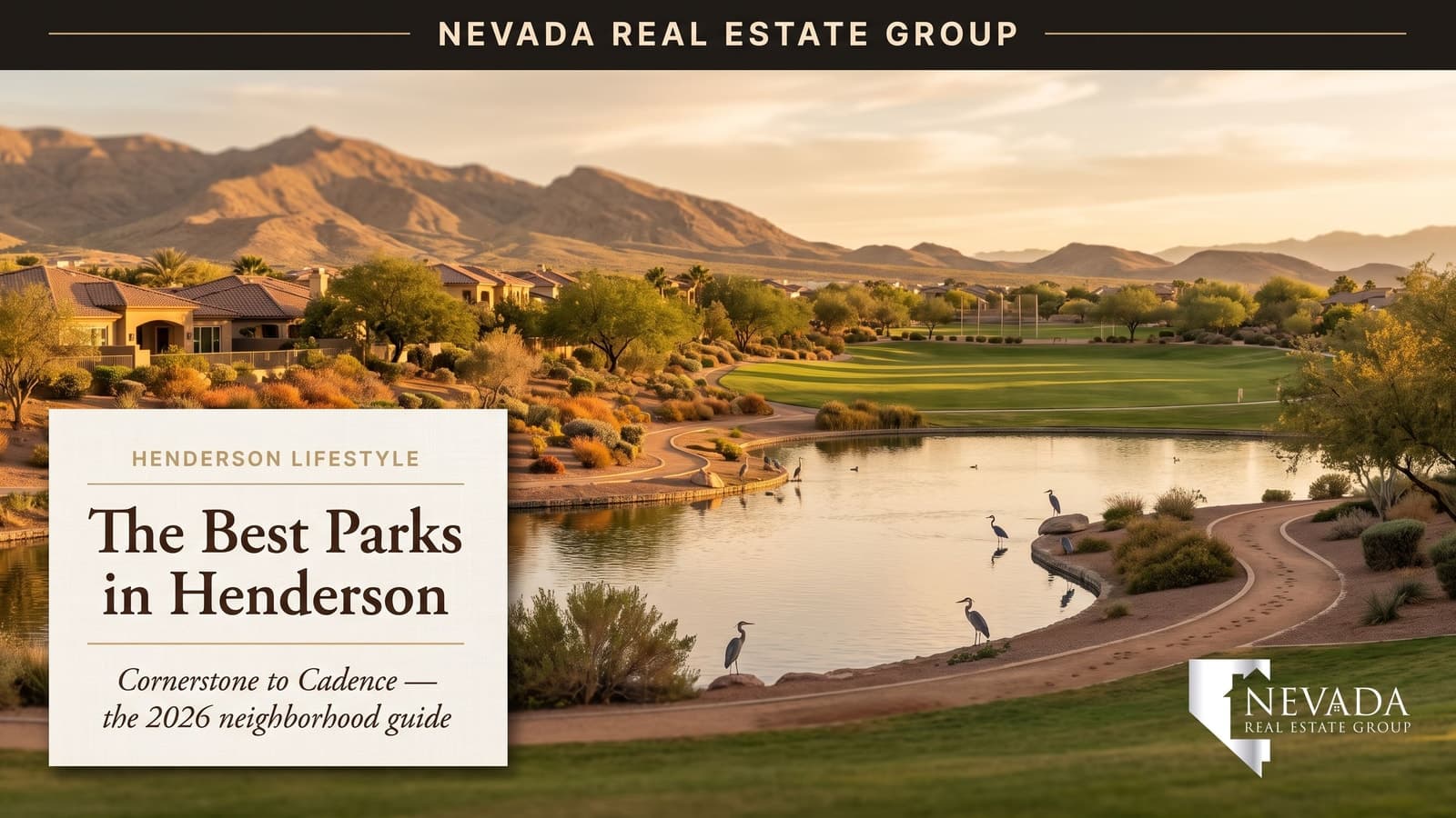 Henderson Nevada community park with desert-landscaped walking path, shaded playground, green sports fields, and the McCullough Range foothills in the background near sunset