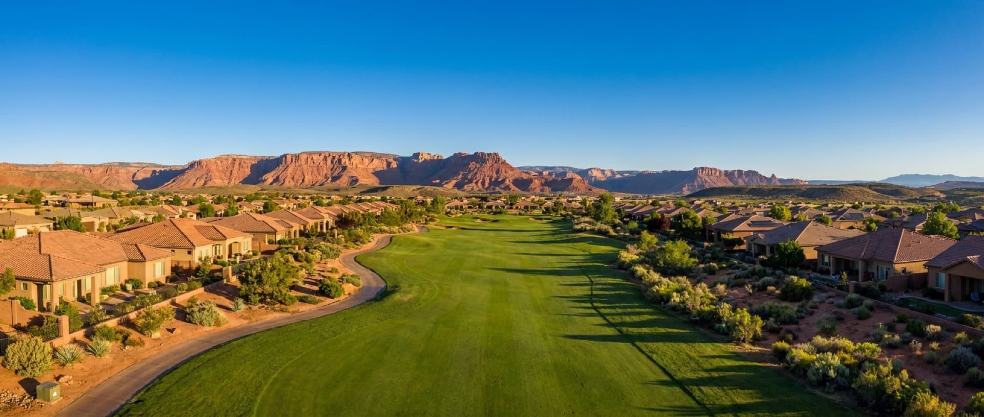 Mesquite, Nevada golf community with red mesa cliffs and the Virgin River valley beyond