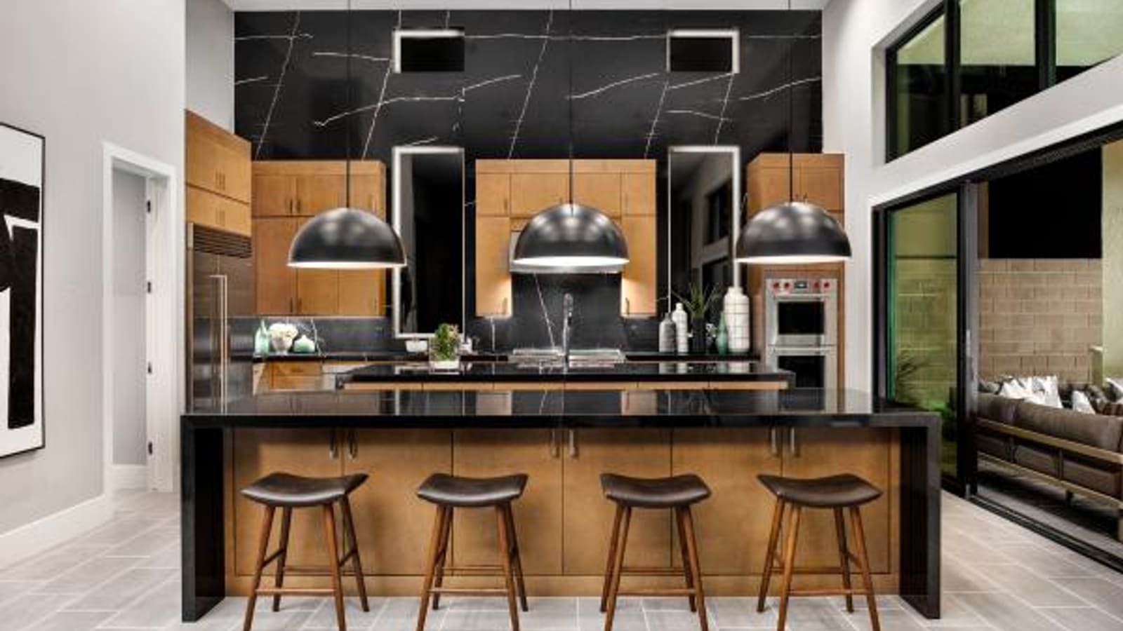 Representative builder image showing custom kitchen cabinetry, island seating, and integrated appliances