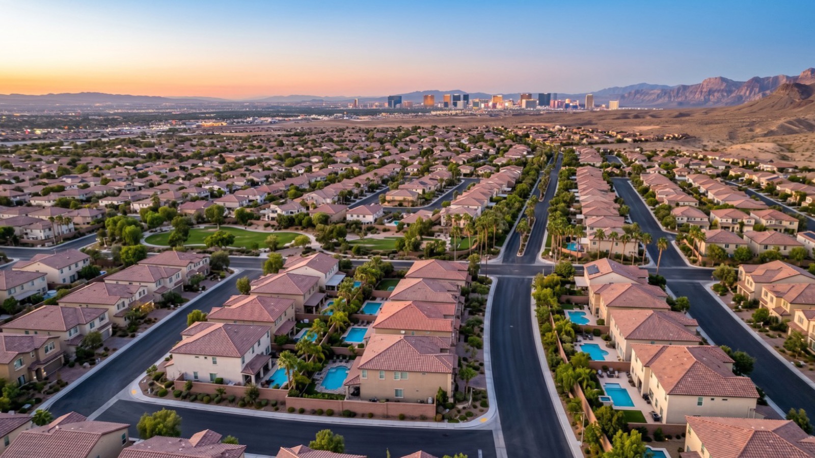 Aerial view of Las Vegas residential neighborhoods with the Strip skyline in the distance, showing the suburban valley where hospital and resort employees buy homes