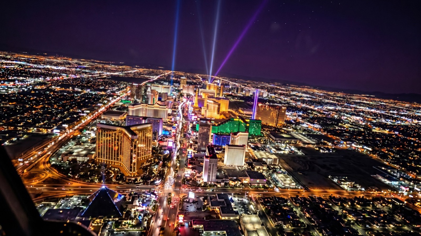 Night view of the Las Vegas Strip skyline with lit resort towers, the Sphere and downtown in the distance