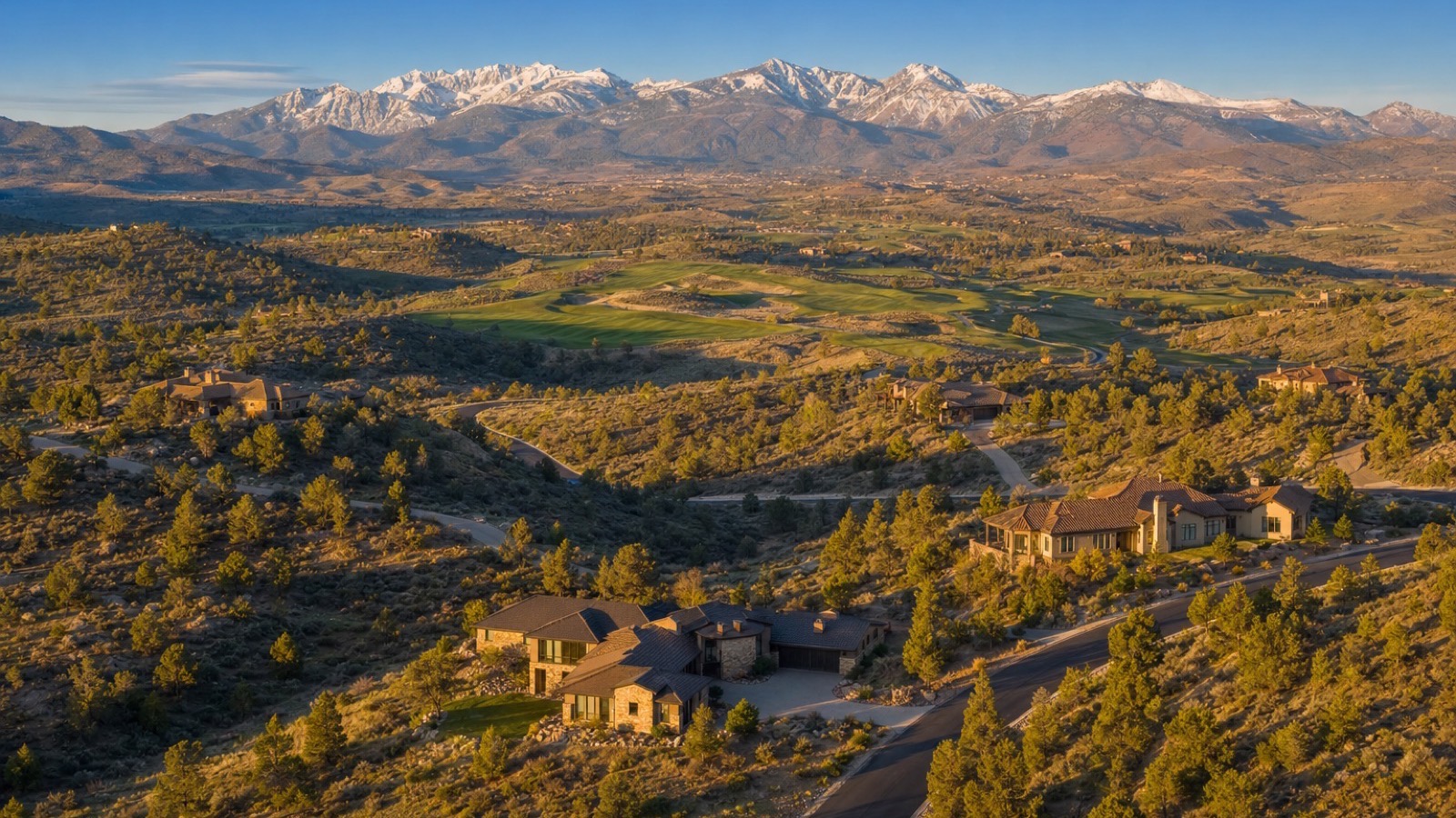 Aerial view of custom homes on large foothill homesites in ArrowCreek in south Reno, Nevada, with the Carson Range and Mount Rose in the distance