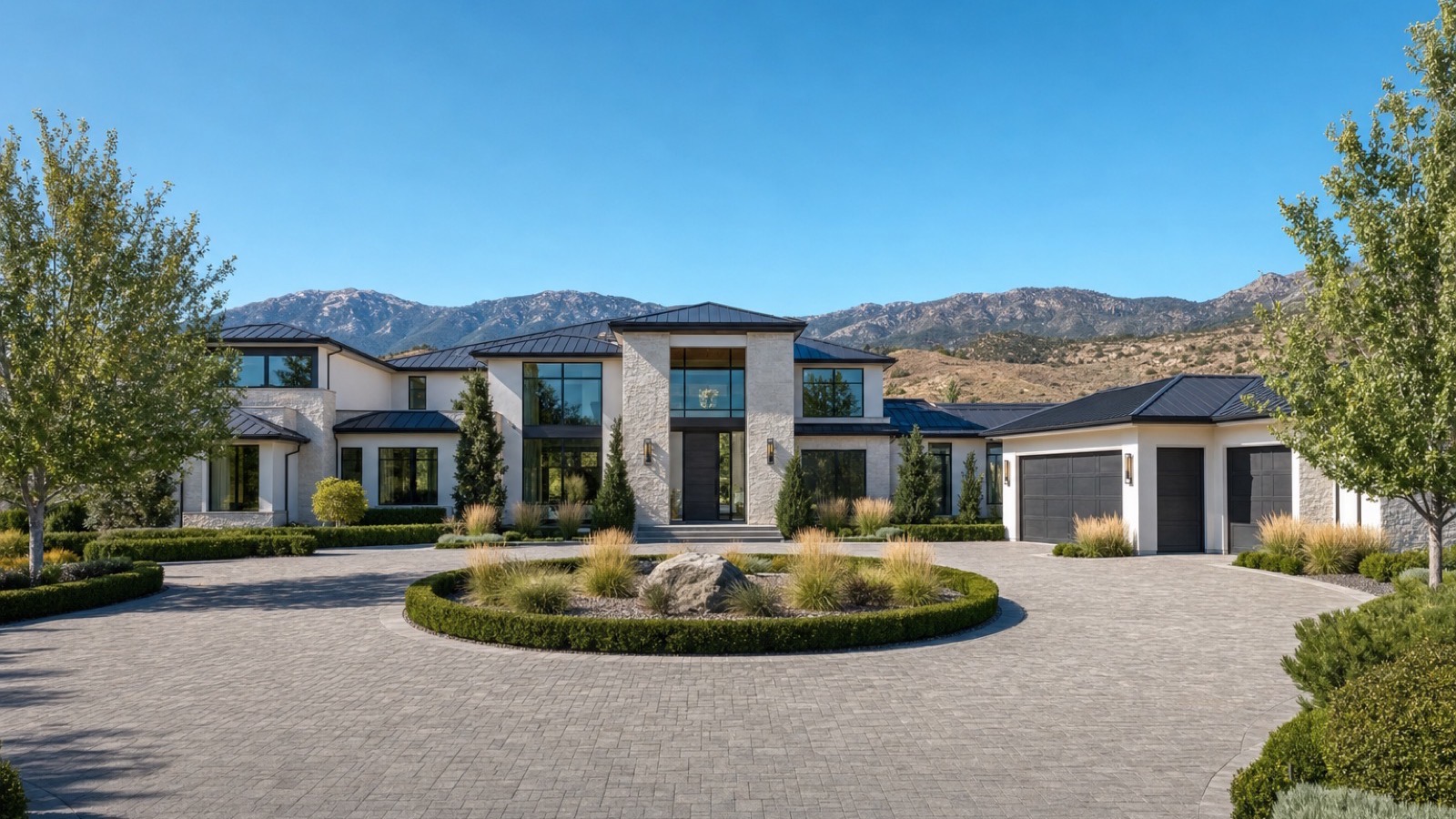 Finished modern custom home with a paver motor court and mountain backdrop in the Reno, Nevada foothills, showing the result of a custom build