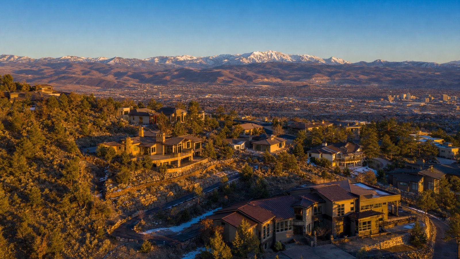 Aerial view of northwest Reno Nevada neighborhoods against the Sierra foothills where wildfire insurance appetite varies by address
