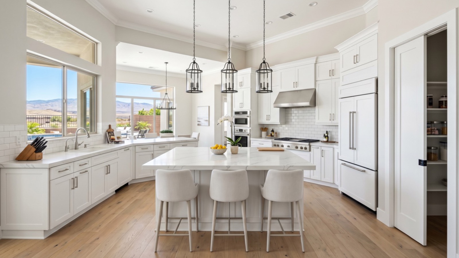 Bright Las Vegas kitchen with a quartz island, white shaker cabinets, a gas cooktop and pendant lights