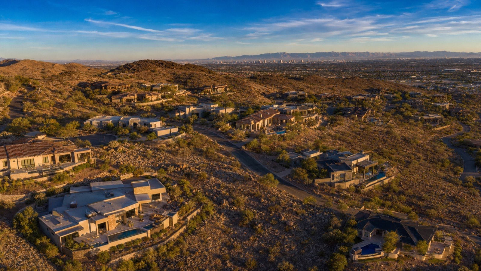Modest single-family homes on an established Las Vegas valley street, typical of the valley's affordable inventory