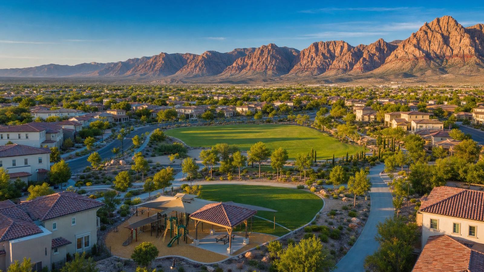Aerial view of a Summerlin village park and homes below the Red Rock escarpment, an HOA community where buyers receive an NRS 116 resale package
