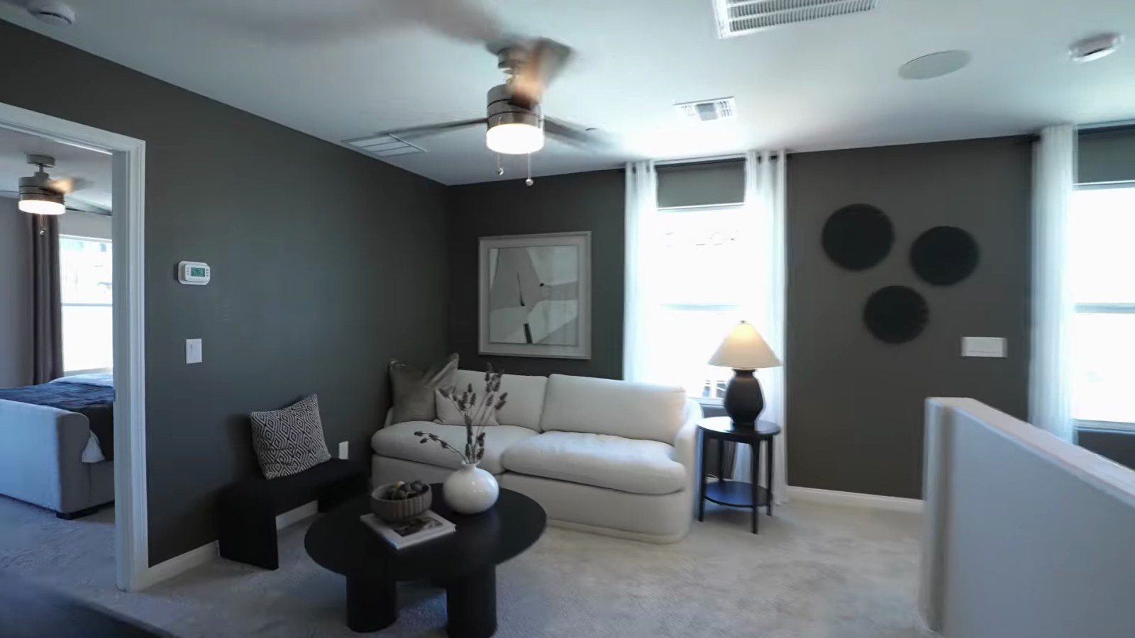Upstairs loft in the KB Home Plan 1850 model at Tobiano furnished as a second living area with a sofa and television