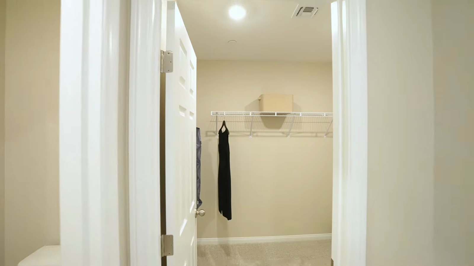 Walk-in primary closet in the KB Home Plan 1850 model at Tobiano with wire shelving on both sides ready for a custom build-out