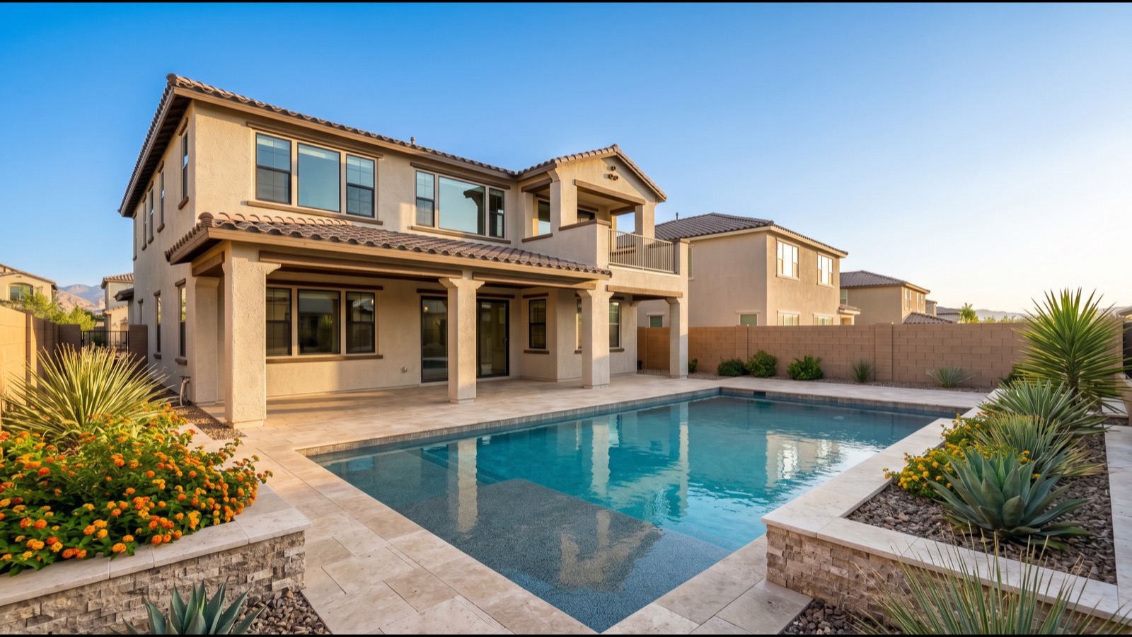 Las Vegas backyard with a rectangular pool, travertine deck, block walls and a two-story stucco home, the kind of private yard a no-HOA owner can modify without architectural review
