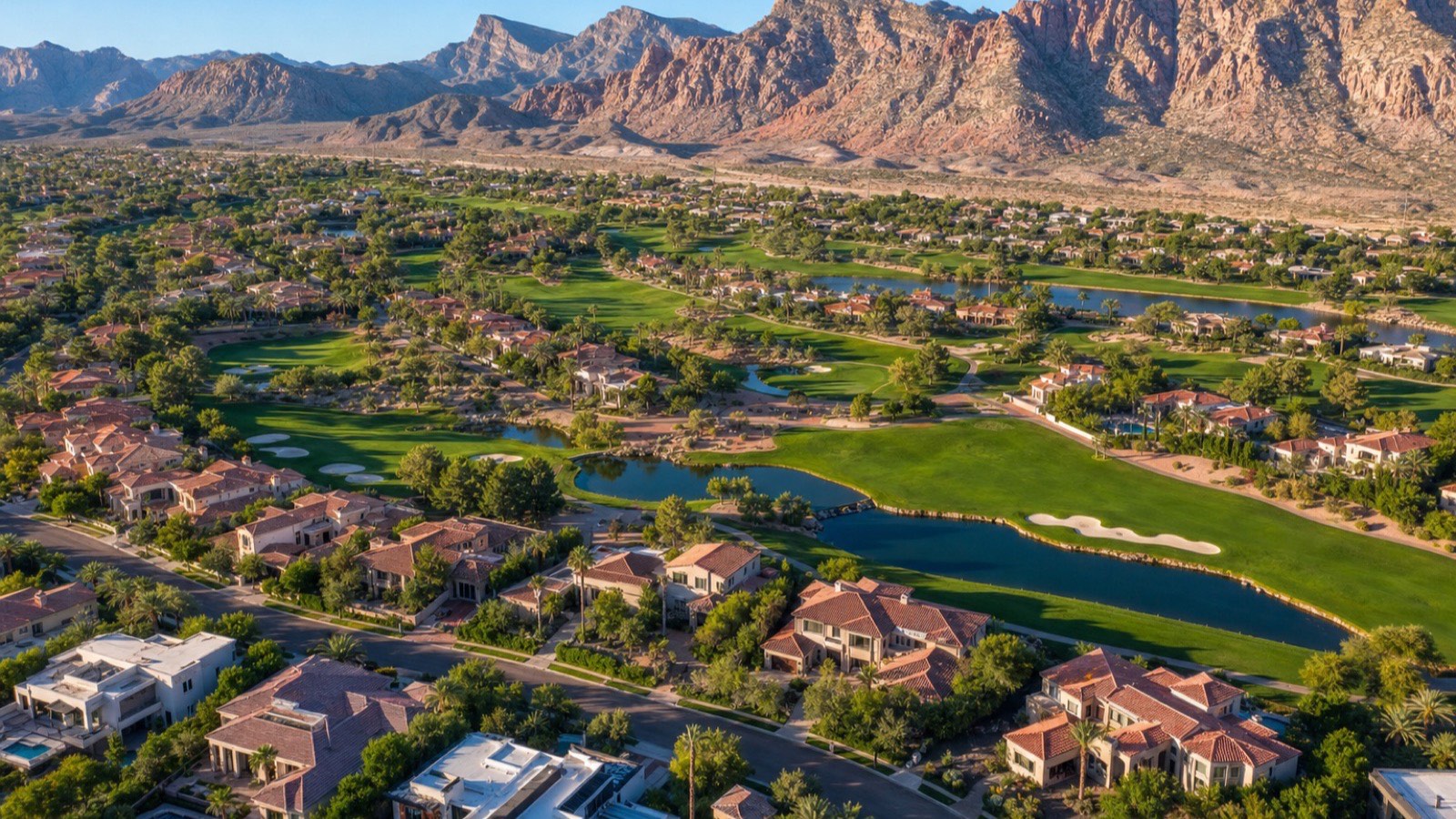 Aerial view of Summerlin homes and golf against the Red Rock escarpment, the Las Vegas master plan most often compared with Palm Springs' country-club living
