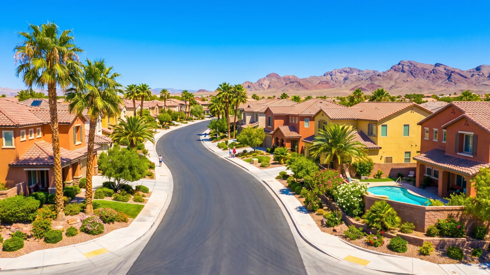 Sunny residential street in a Las Vegas neighborhood with single-story homes and desert landscaping