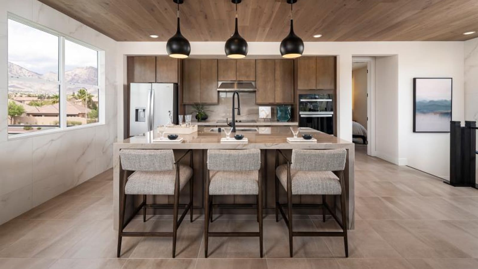 Kitchen interior with center island and compact footprint design at The Loughton