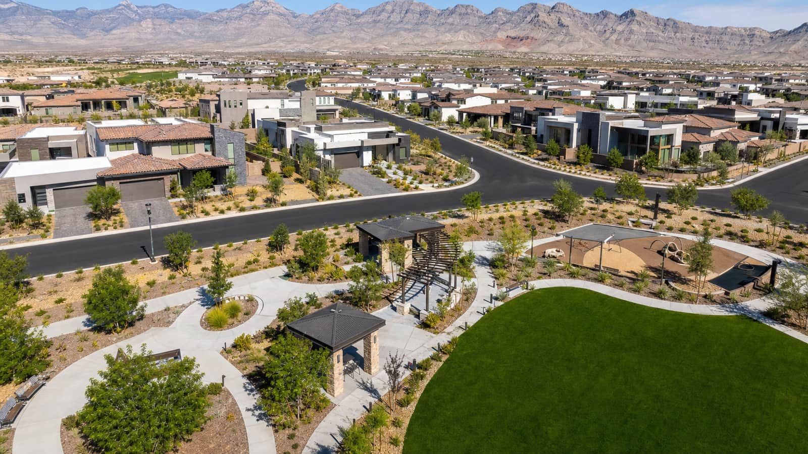 Aerial view of new construction homes and a neighborhood park in Skye Canyon, northwest Las Vegas, with mountains behind in 2026