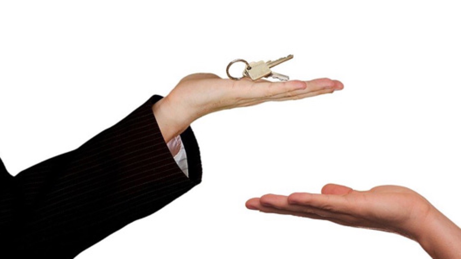 Nevada real estate agent handing house keys to a new homeowner after a Las Vegas closing