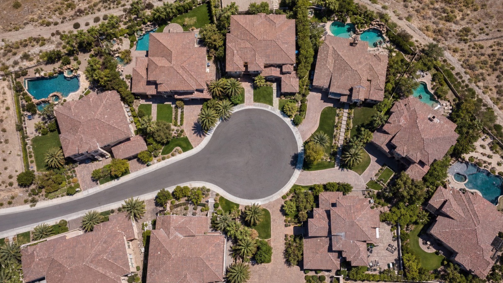Aerial view of a Henderson cul-de-sac with concrete tile roofs, backyard pools and desert landscaping