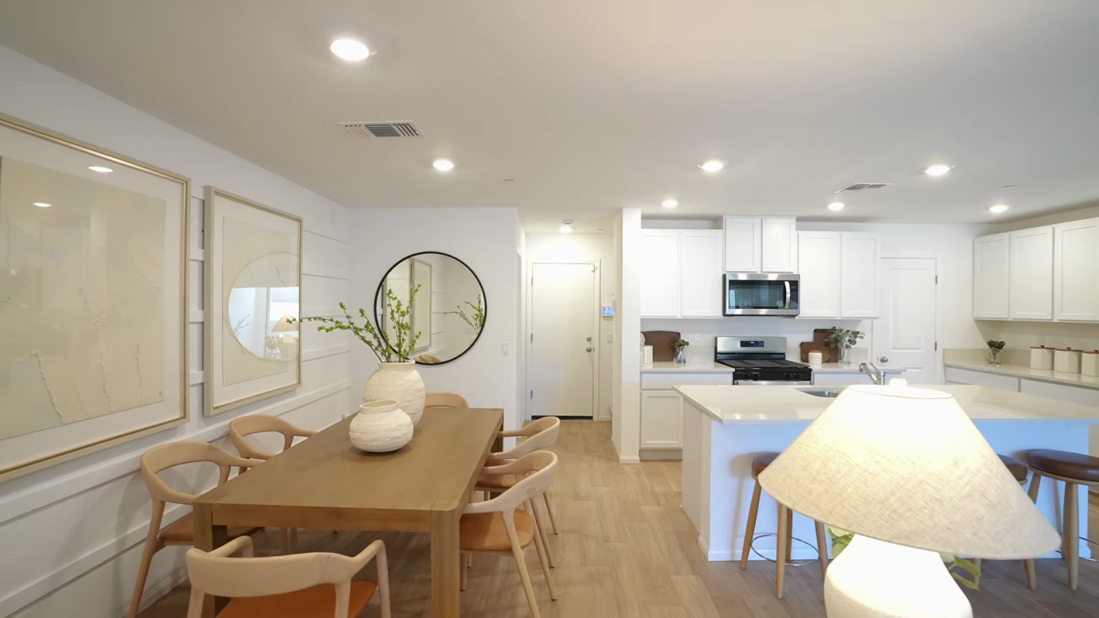 Open-concept main floor of the Pulte Branton model at Dalea at Aries with the dining area, island kitchen and living room in one space