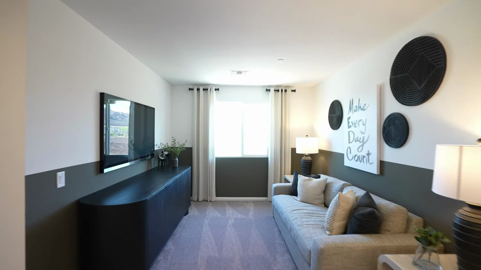 Upstairs loft in the Pulte Danbury model at Dalea at Aries staged with a sofa, side table and media console under a window