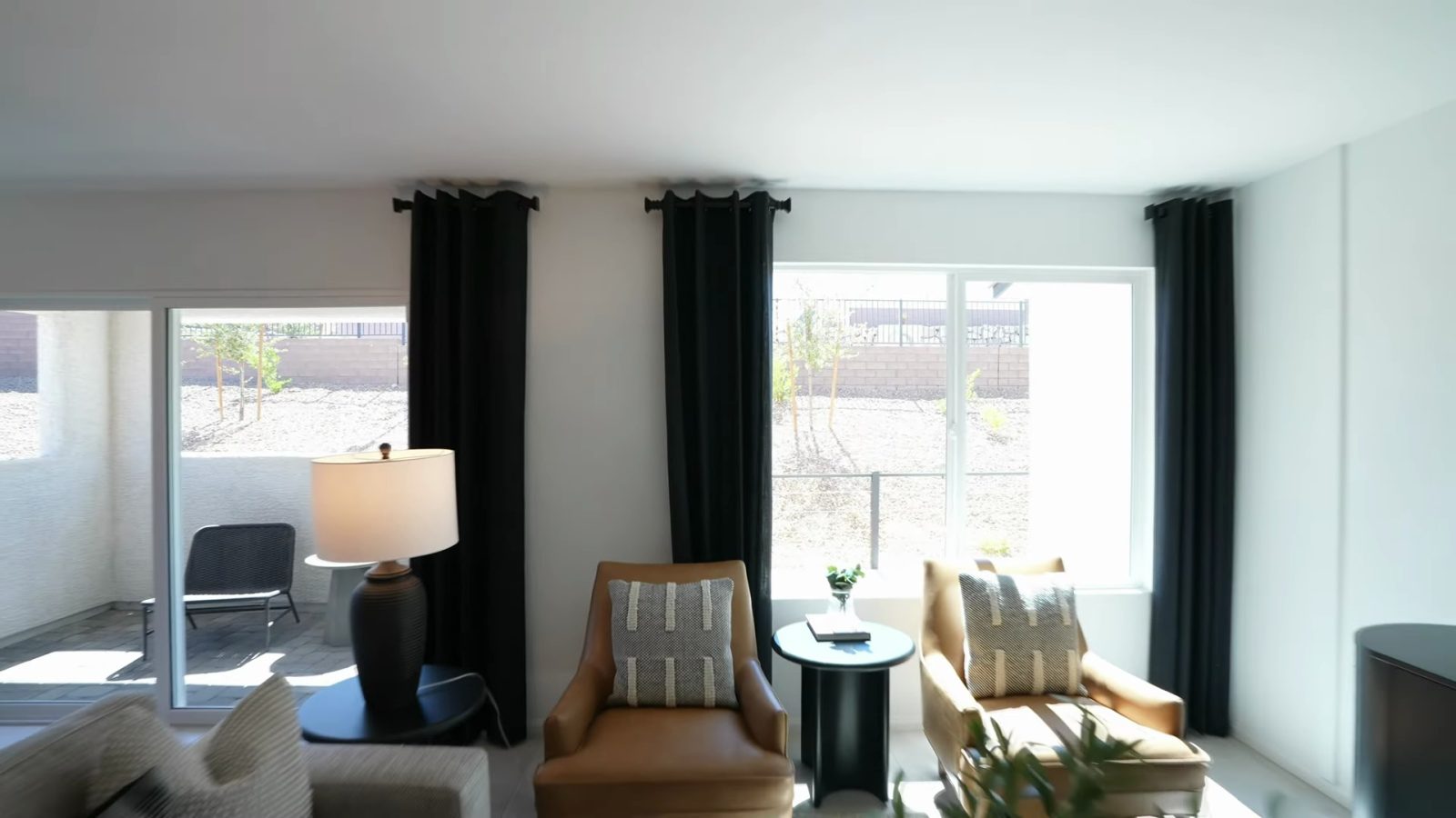 Living area of the Pulte Danbury model at Dalea at Aries with a sliding door opening to the covered loggia and block wall