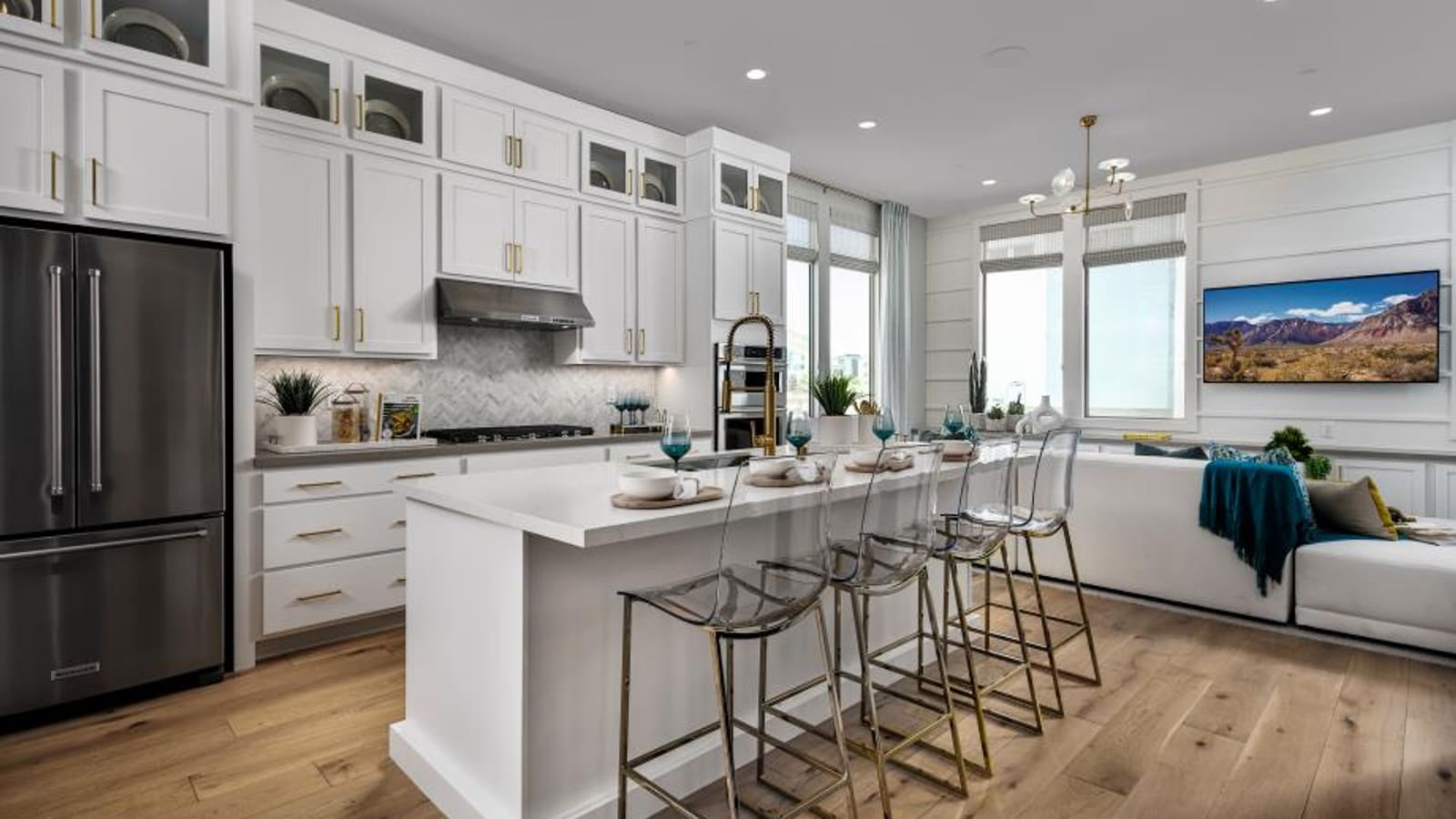 Representative builder image of a kitchen layout in a townhome showing cabinetry and a central island