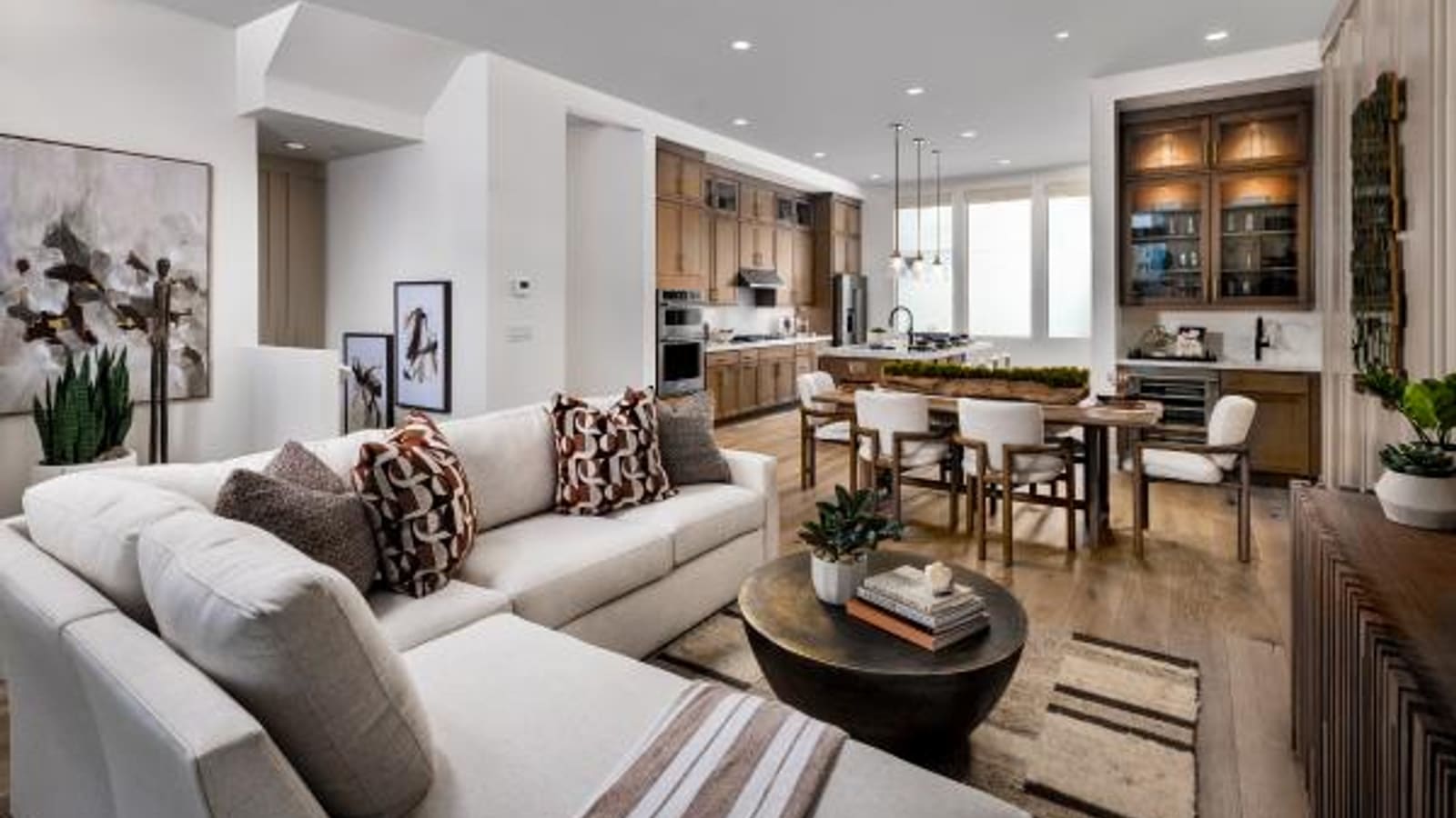 Representative builder image of a living room space with contemporary furnishings and large windows