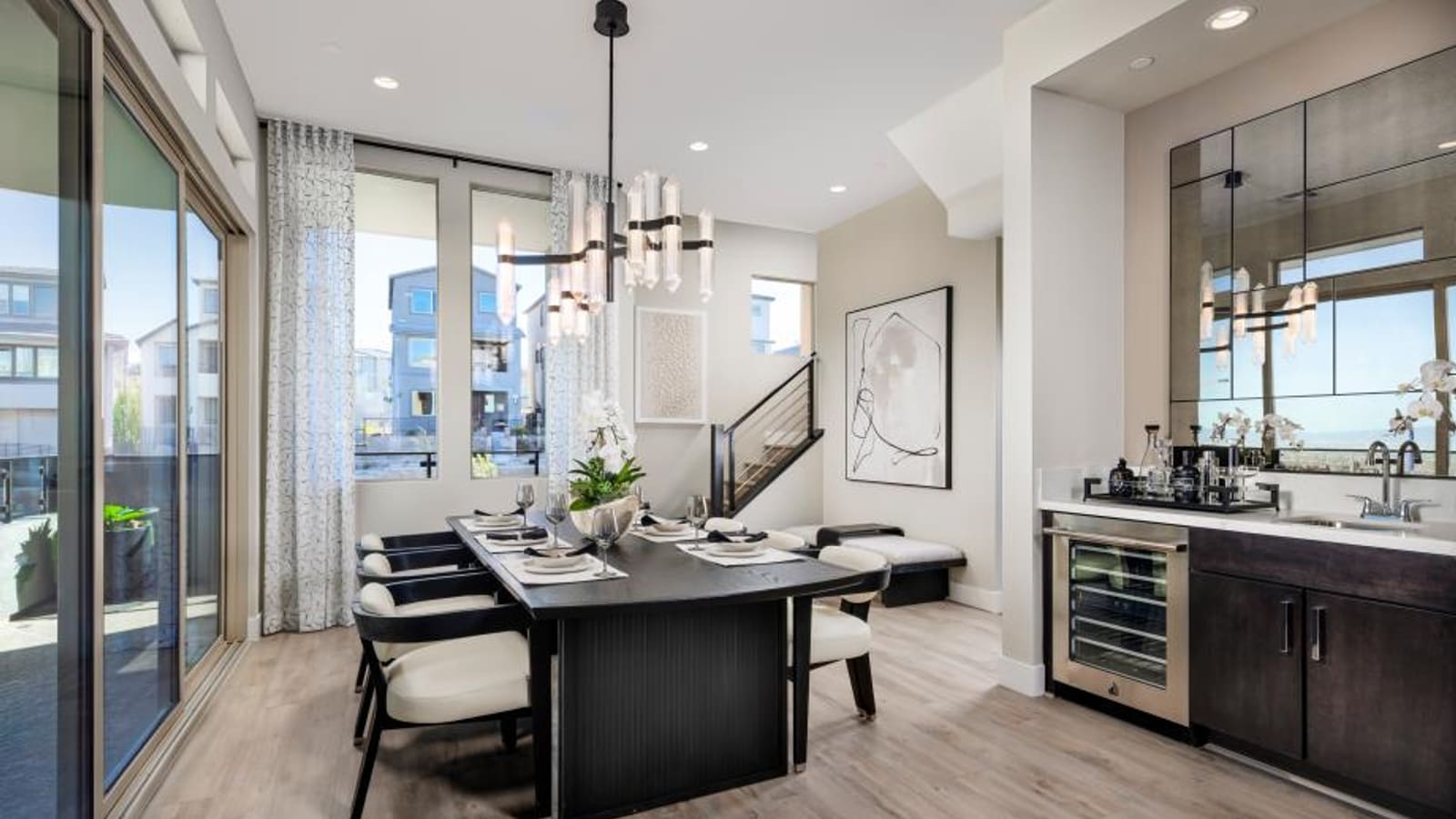 Representative builder image of a casual dining space adjacent to a kitchen with contemporary lighting fixtures