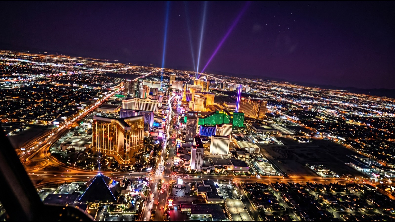 Night aerial of the Las Vegas Strip and the surrounding valley grid of homes, the metro that 42,468 Clark County tax-filing households left for another state in the 2022 to 2023 IRS migration file