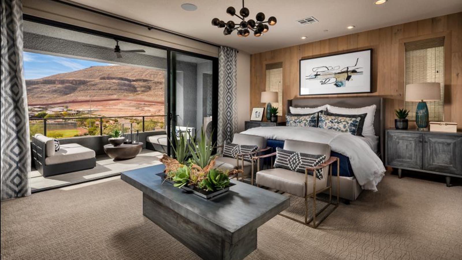Spacious primary bedroom suite with large windows and neutral decor