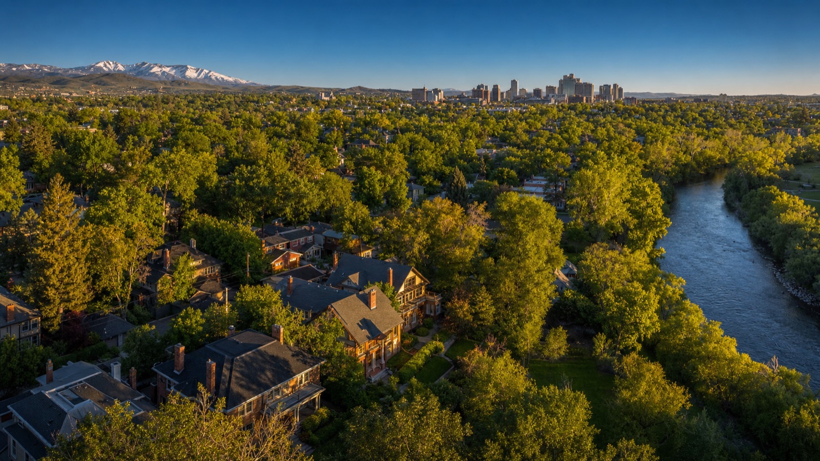 Aerial view of an established Reno neighborhood with tree-lined streets and the Sierra Nevada beyond, the resale market where Northern Nevada closing customs apply