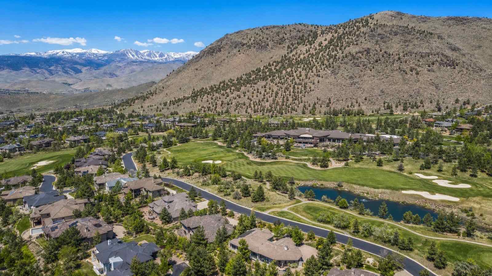 Aerial view of Somersett golf-course homes and clubhouse below the hills of northwest Reno