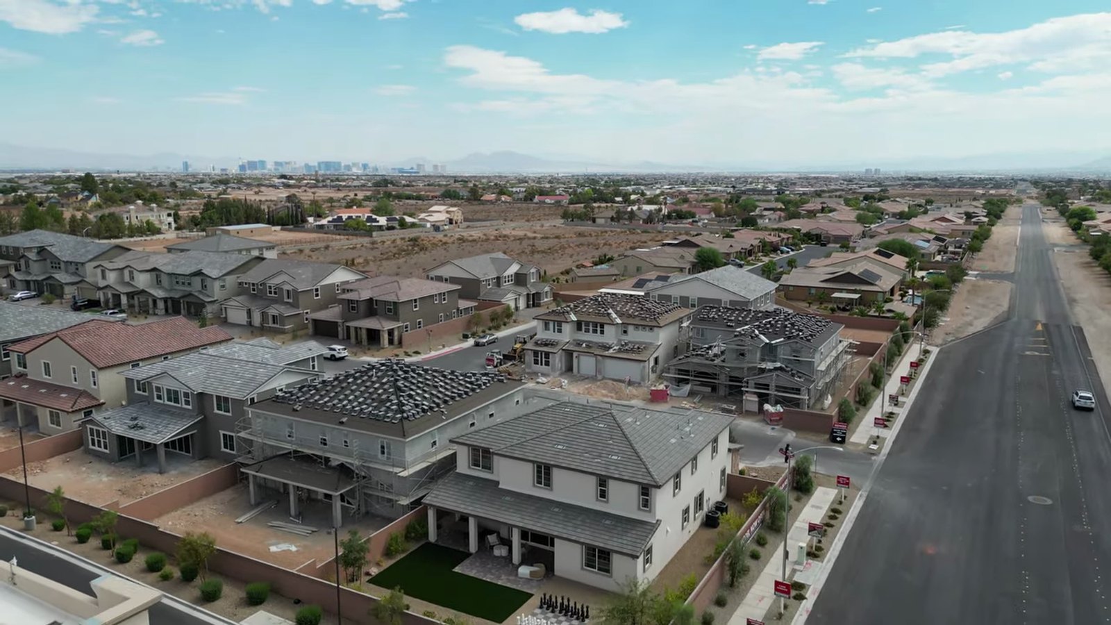 Aerial view of Richmond American's Silver Bow neighborhood in southwest Las Vegas with homes under construction and the Strip on the horizon