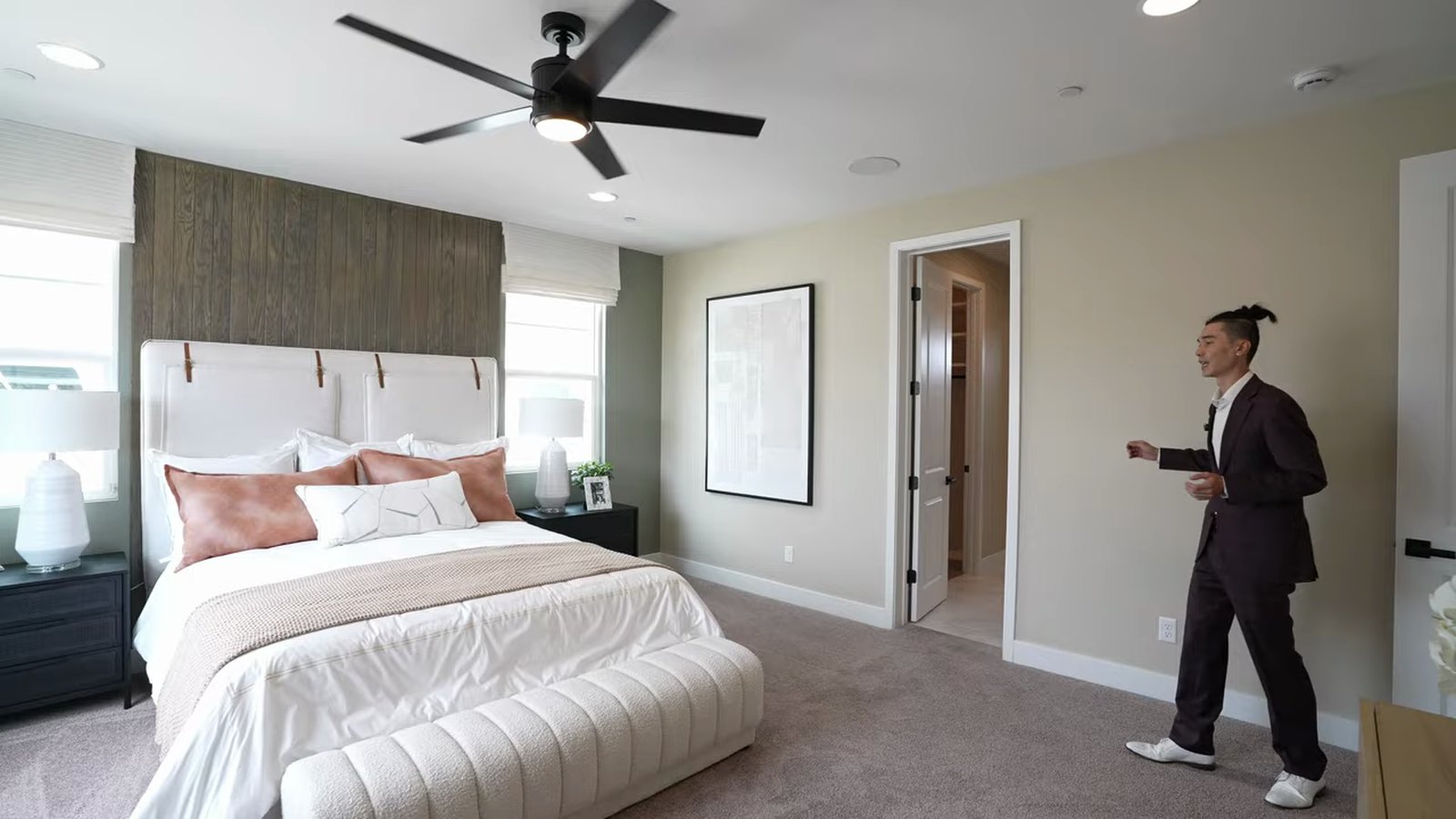 Primary bedroom in the Richmond American Dayton model at Silver Bow with a king bed and a door to the closets