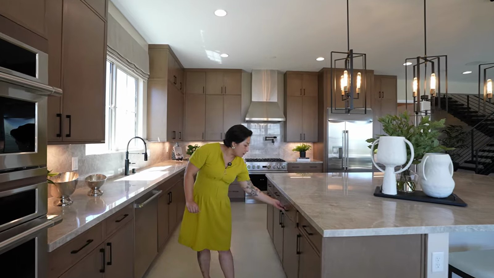 Richmond American Teton model kitchen with a large quartz island, Monogram appliances and a six-burner range