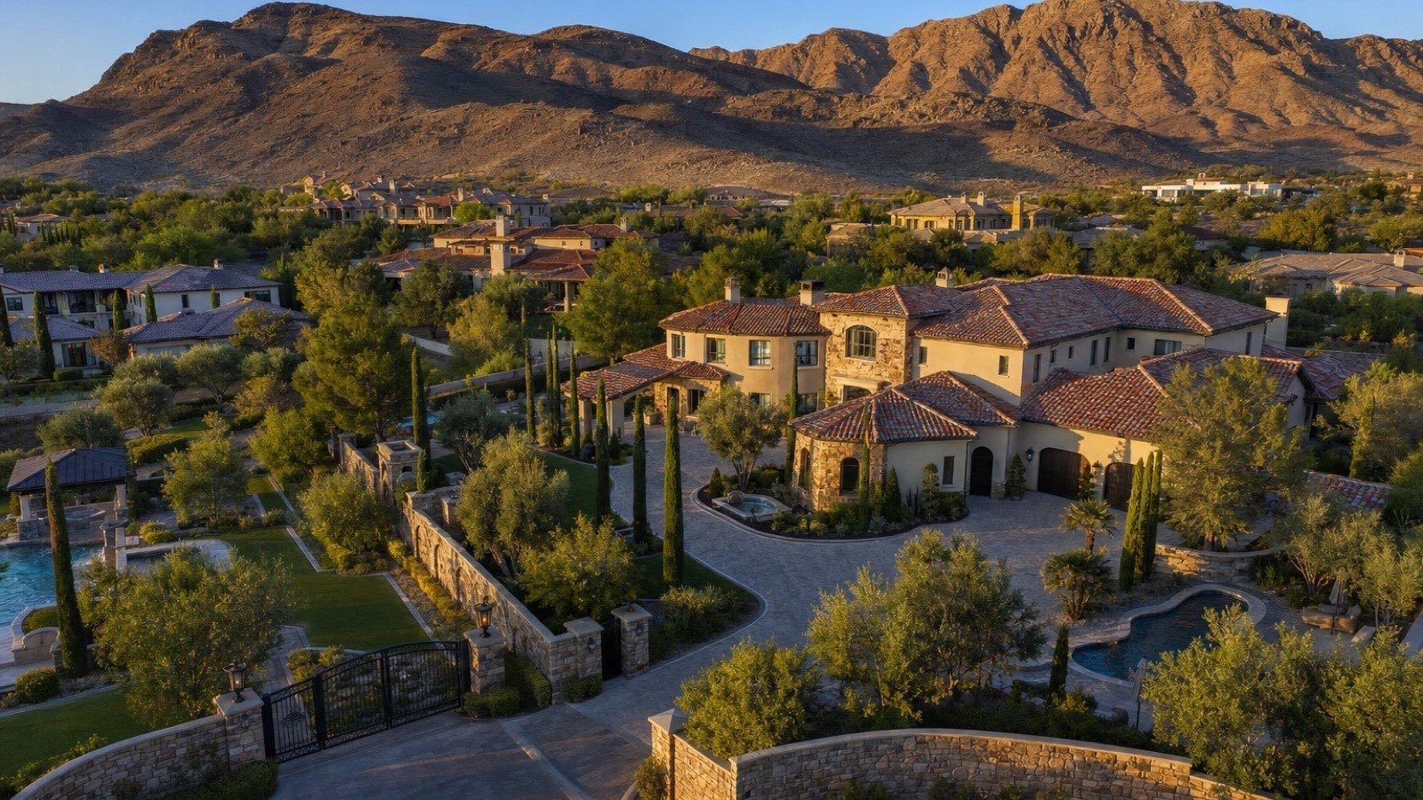 Aerial of Roma Hills gated Tuscan-style estates in Henderson with the Black Mountain foothills of the McCullough Range behind them