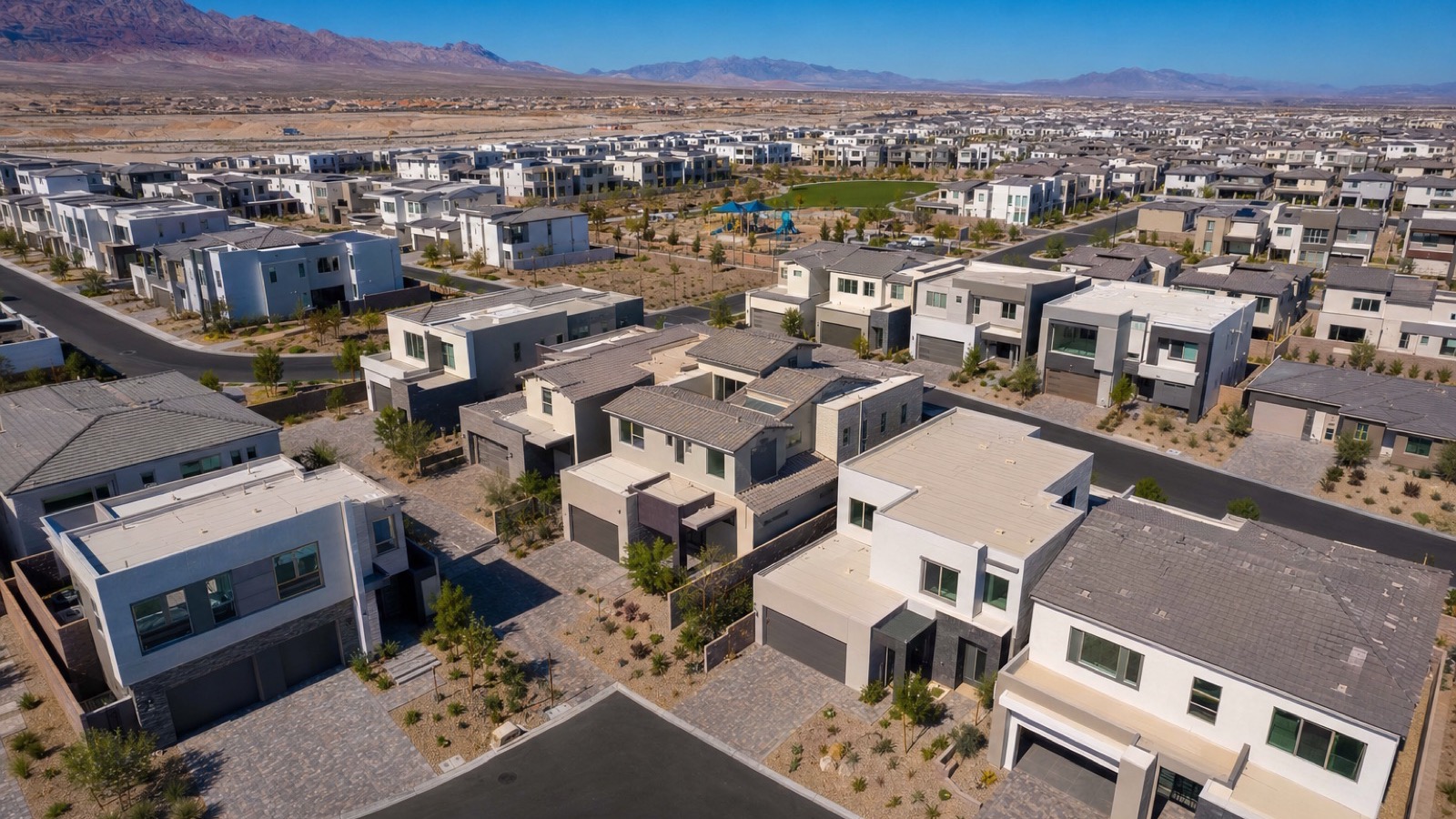 Aerial view of a new construction neighborhood under development in Henderson Nevada with framed homes and graded lots