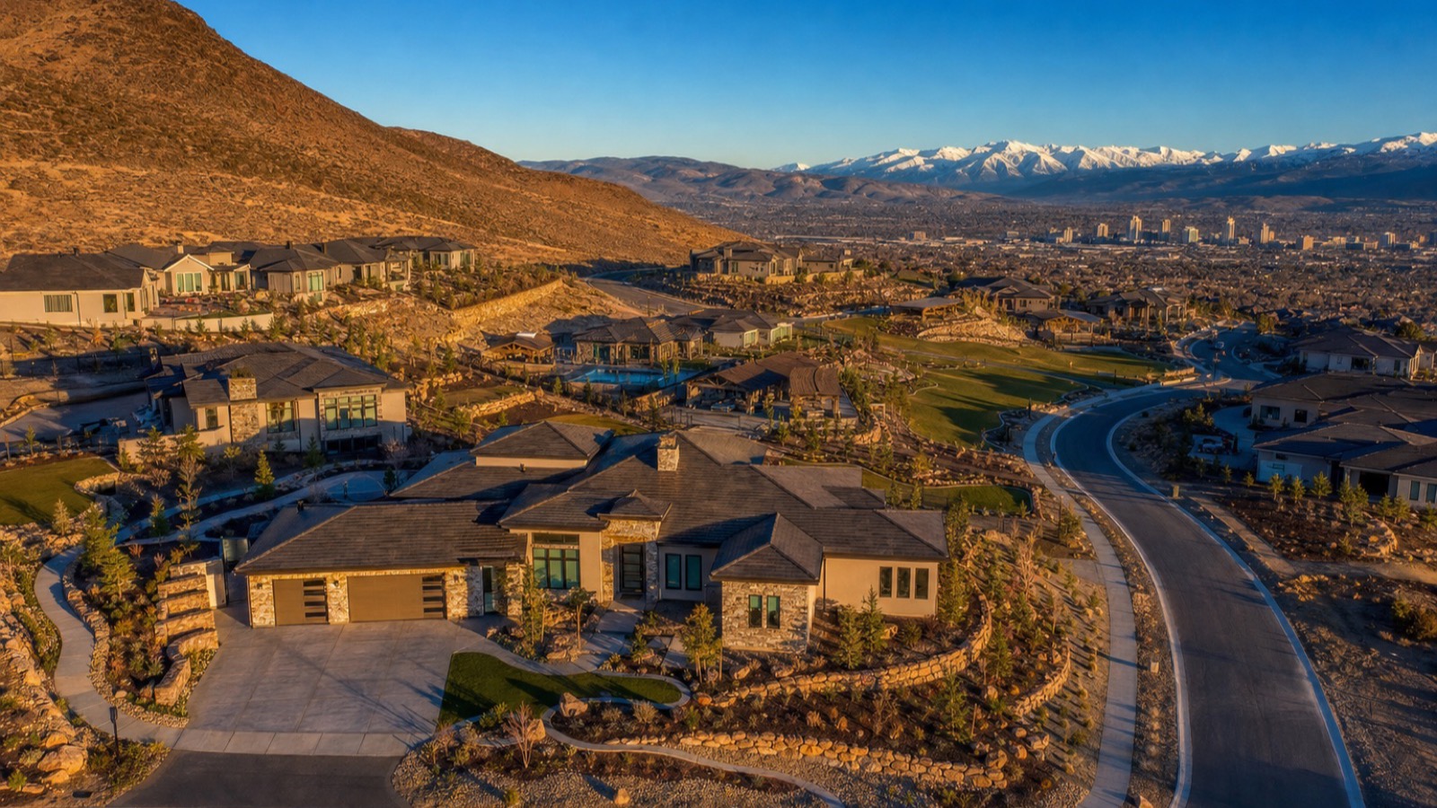 Aerial view of a newer master-planned neighborhood in Sparks Nevada with uniform tile-roof homes and landscaped streets