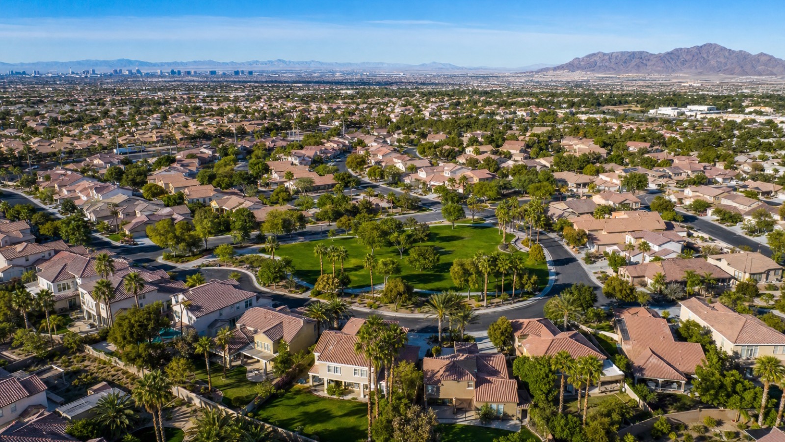 Silverado Ranch south Las Vegas residential streetscape with mature landscaping and Spring Mountains backdrop