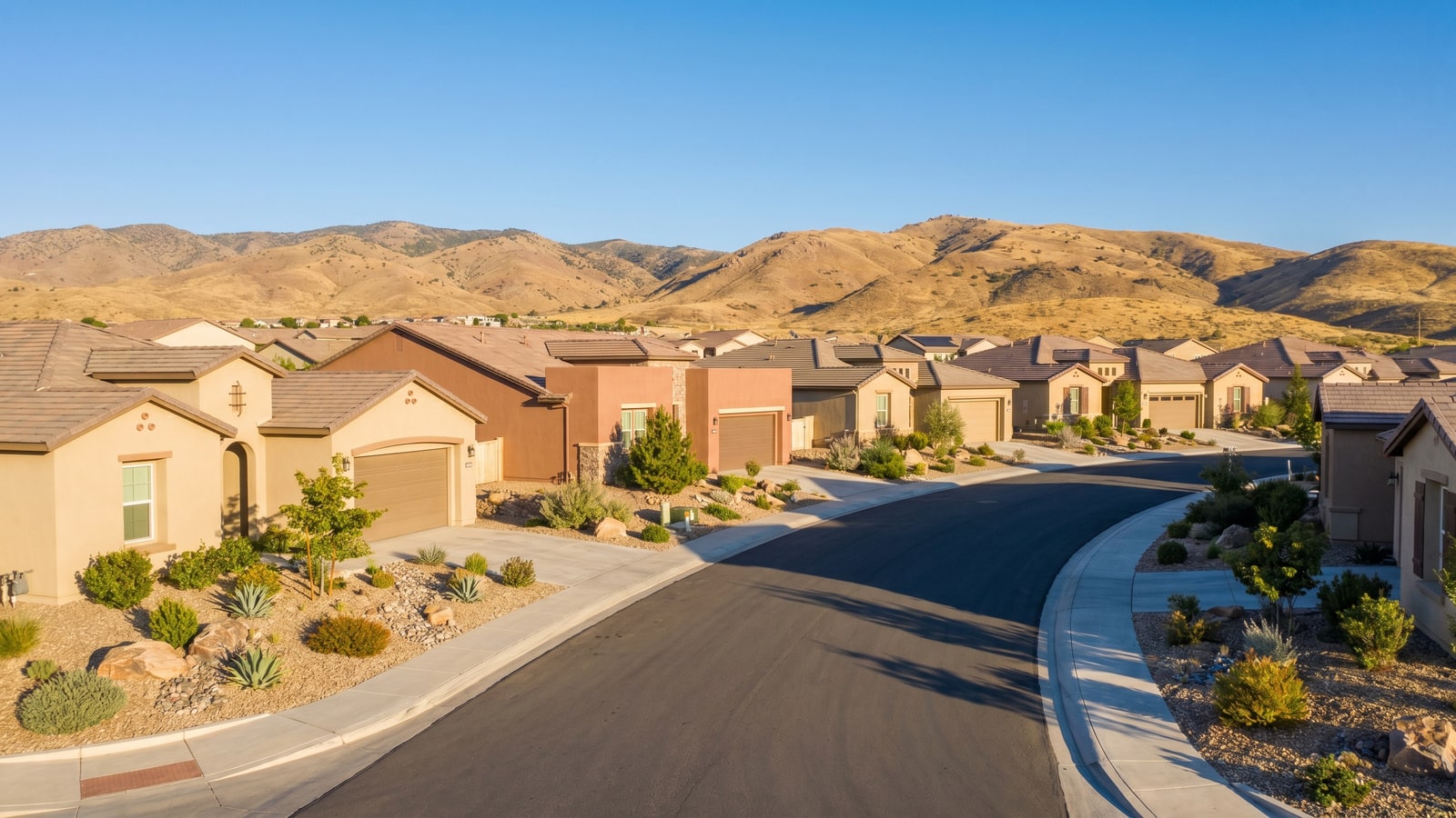 A modern South Reno, Nevada residential neighborhood of new single-family homes with the Sierra Nevada foothills behind