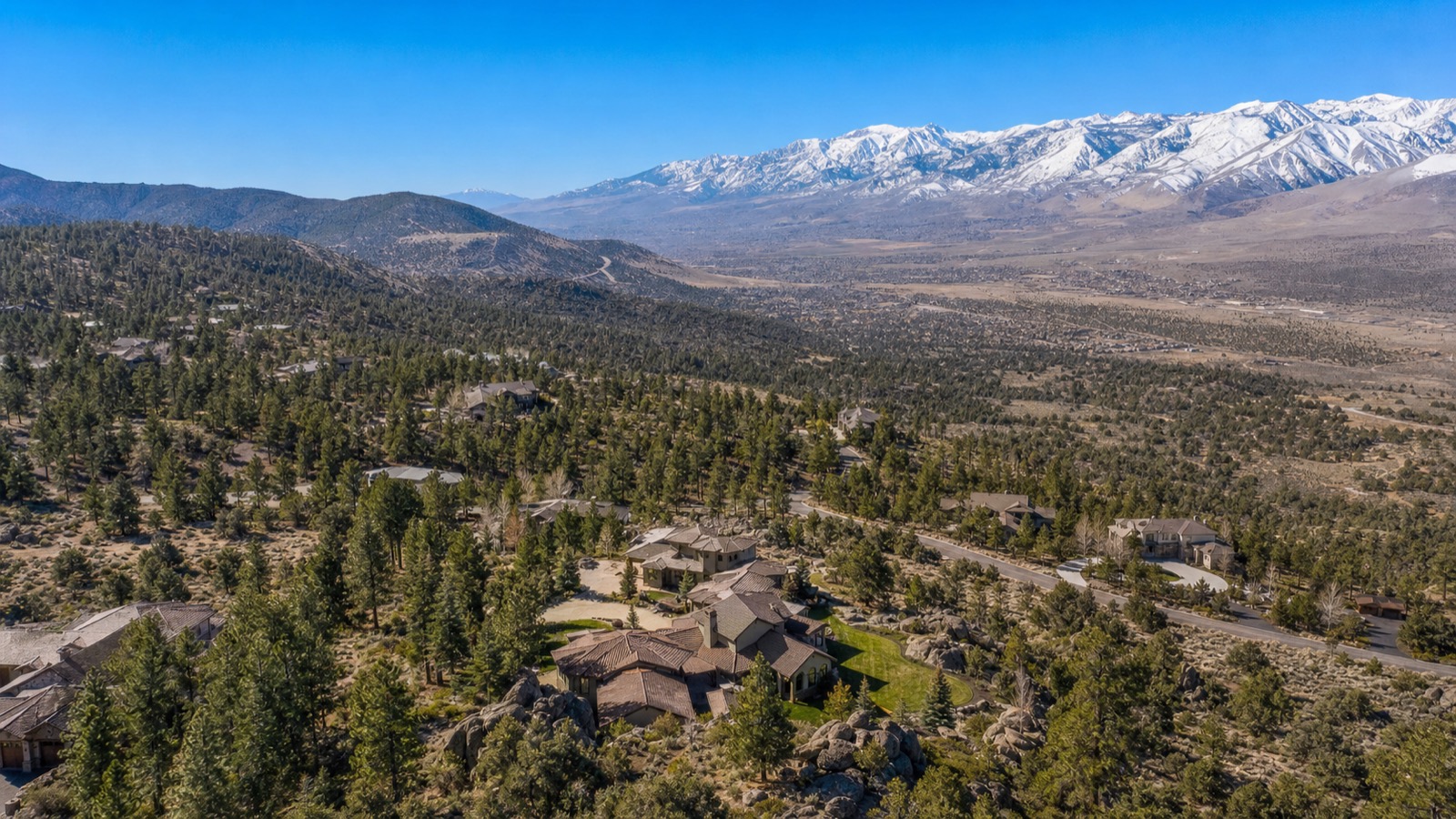 Aerial view of South Reno along the Mt. Rose Highway corridor with foothill neighborhoods rising toward the Sierra Nevada