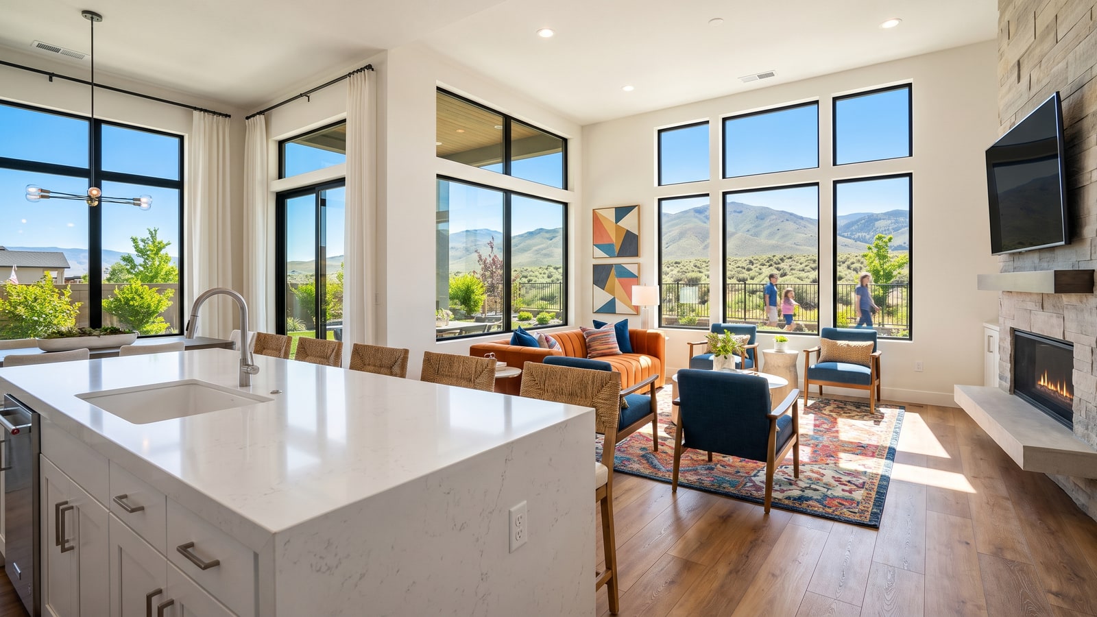 Bright model home great room in a new Sparks Nevada construction community with quartz kitchen island and mountain views through large windows