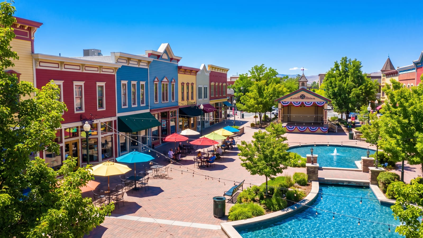 Victorian Square style downtown plaza in Sparks Nevada with colorful storefronts and event stage — downtown Sparks redevelopment and the housing market
