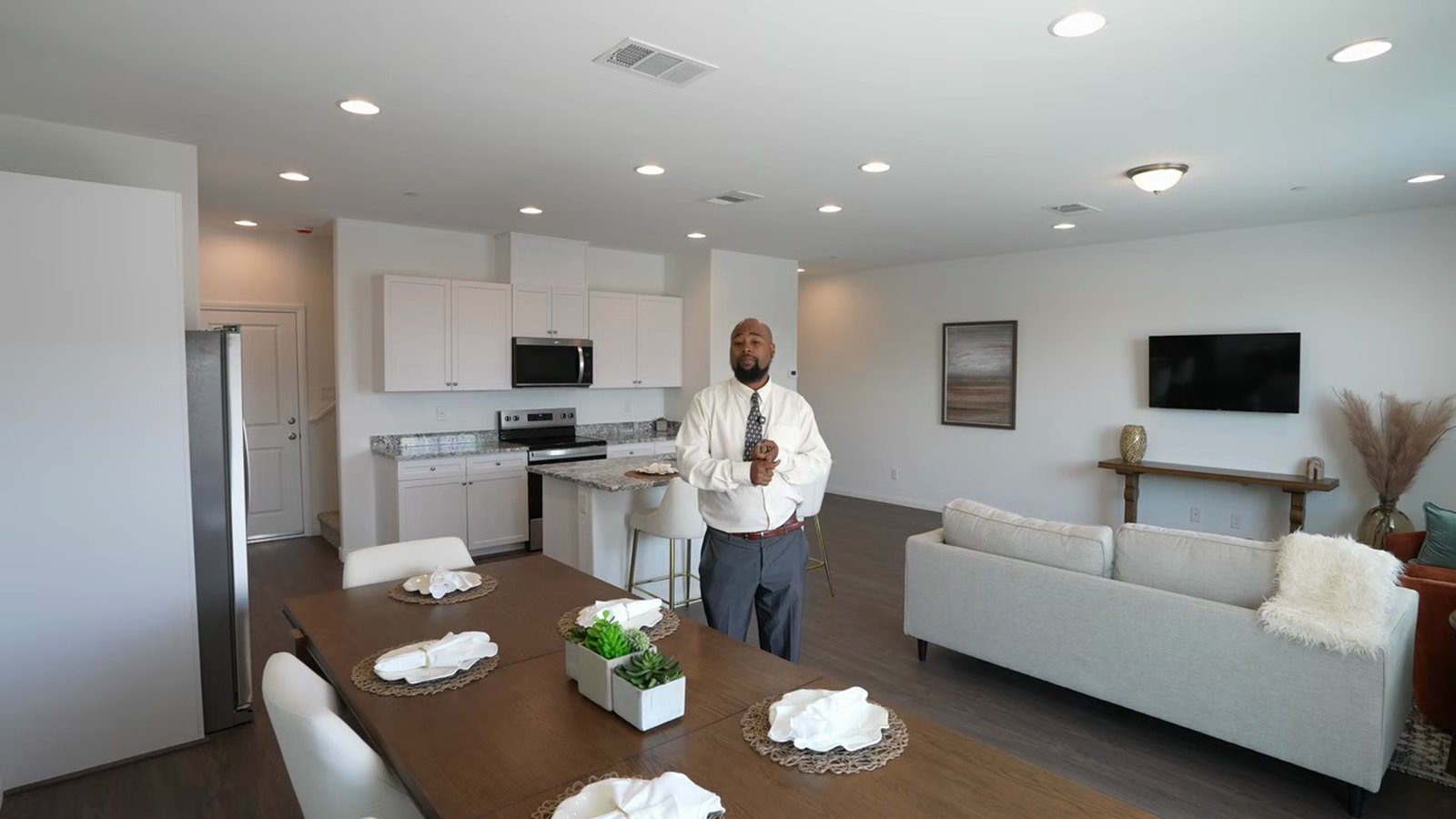 Arroway model great room at Parkhill Crest with dining table, sofa and open kitchen under 9-foot ceilings with vinyl plank floors