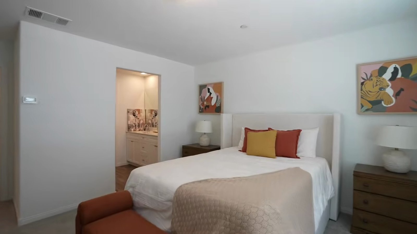Arroway model primary bedroom with a queen bed, nightstands and a doorway to the primary bathroom vanity