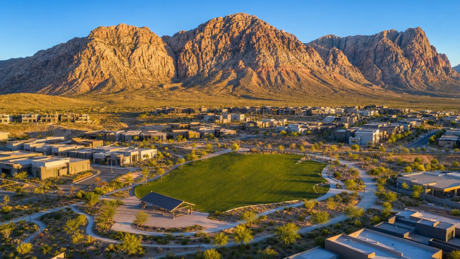 Aerial of a Summerlin West neighborhood park and new contemporary homes at the foot of the Red Rock escarpment in Las Vegas