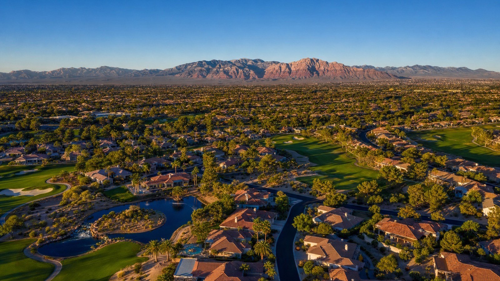 Sun City Summerlin streets and golf course from above with the Summerlin master plan and the Spring Mountains in the distance