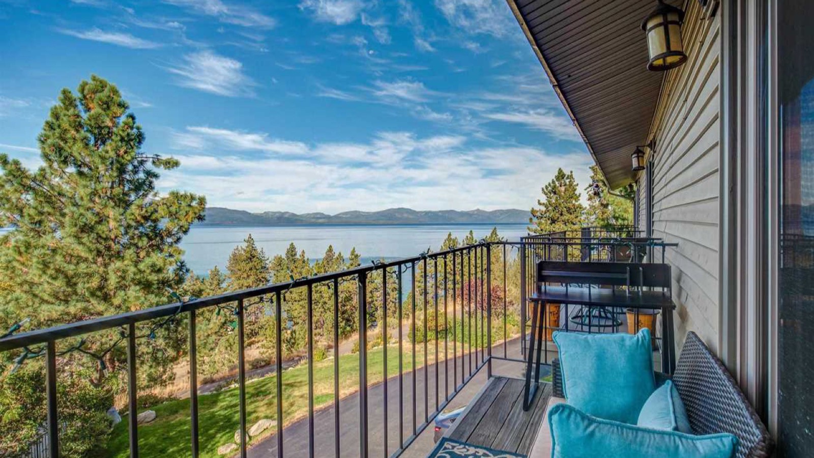 Deck of a Nevada Lake Tahoe home overlooking the lake through pine trees