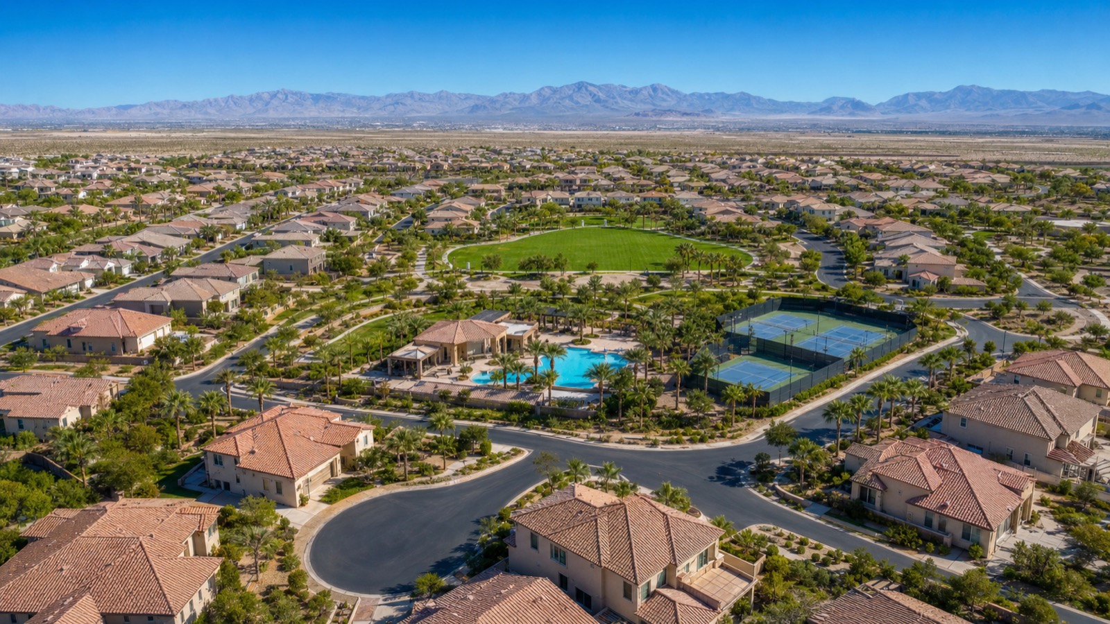 Providence Las Vegas residential streetscape at midday with manicured landscaping and tile-roof homes