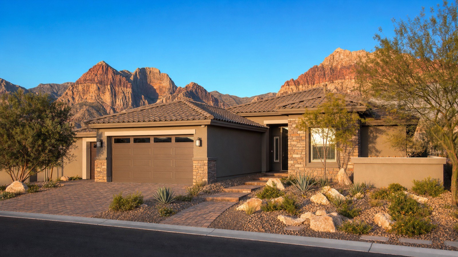 Modern single-story home with desert landscaping in a Summerlin 55+ community, the detached product Regency by Toll Brothers sells