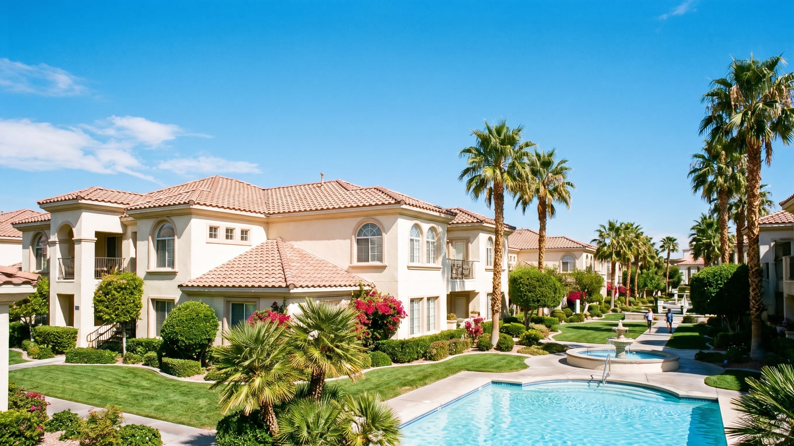 Mediterranean-style two-story condominium buildings with terracotta roofs and palm trees in southwest Las Vegas