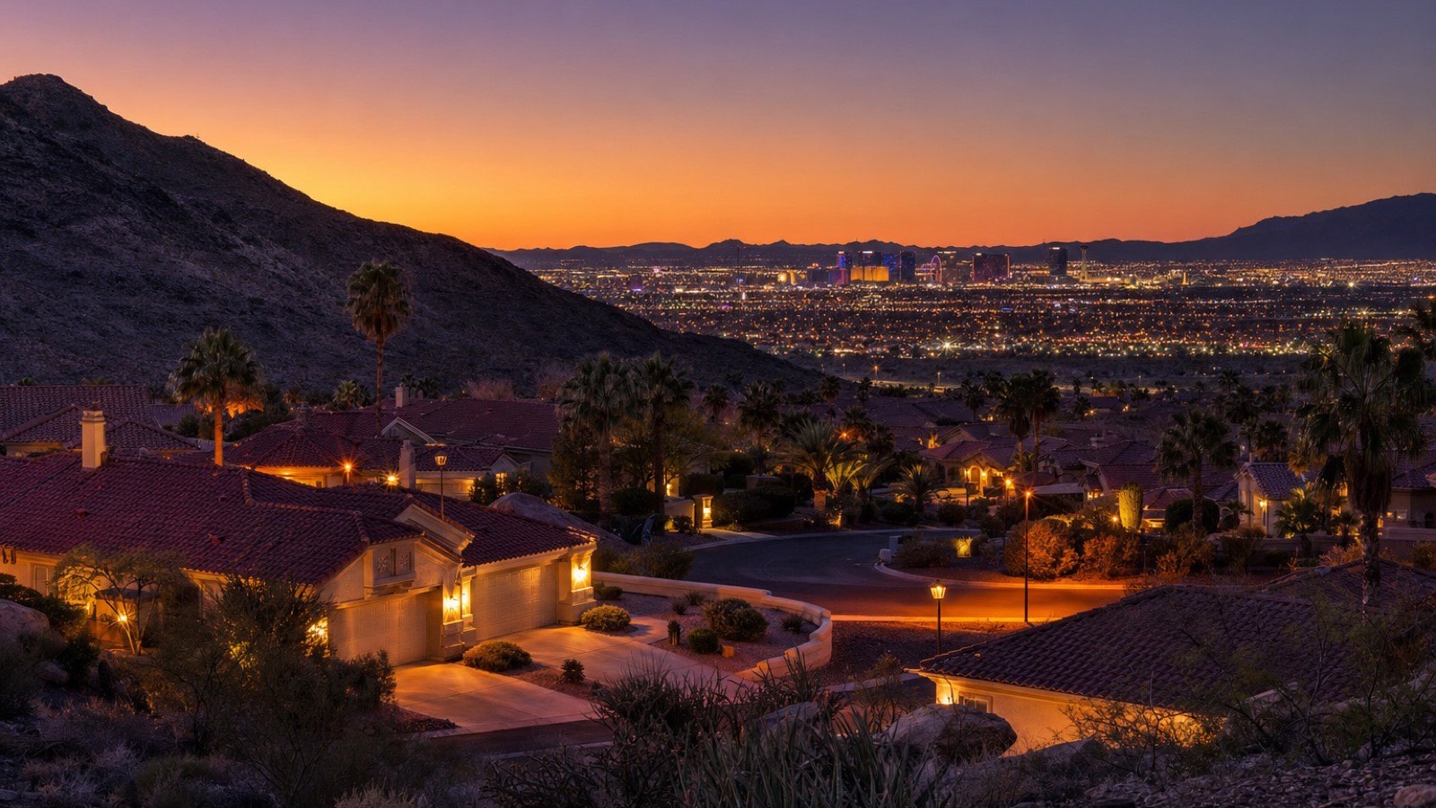Twilight view over a Las Vegas 55+ community with pools and single-story homes, the active-adult housing the desert cities offer